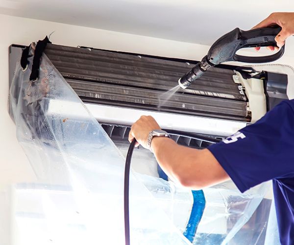 HVAC technician servicing a home heating system in Estes Park, CO